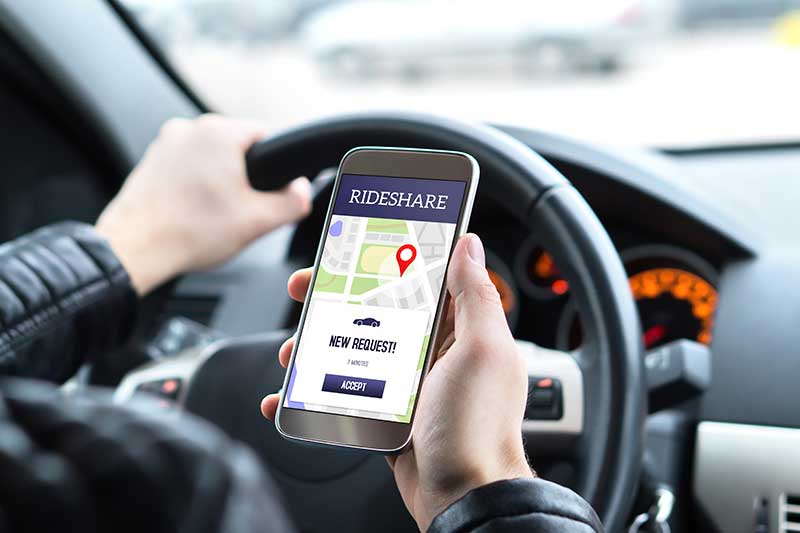 A rideshare driver looking at their phone.