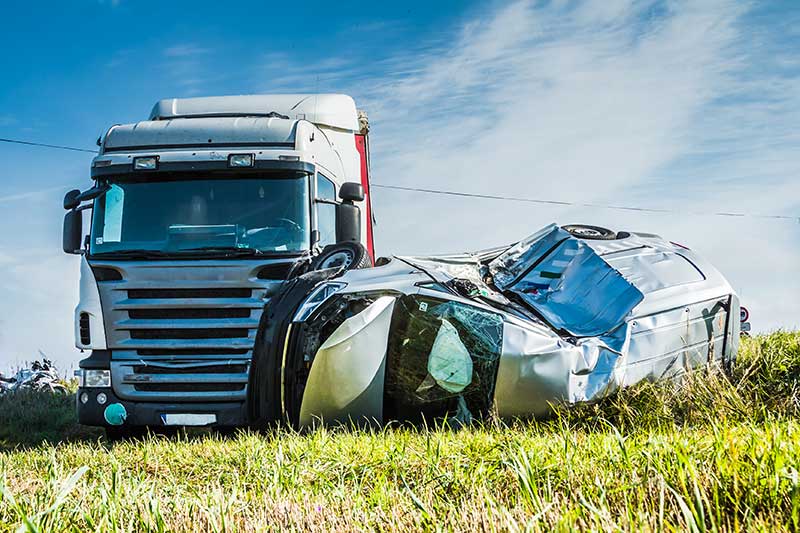 A scene of a truck that hit a car
